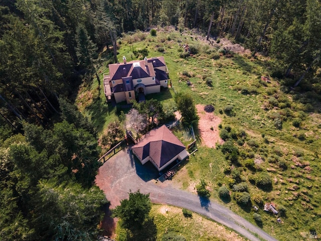 drone / aerial view with a wooded view