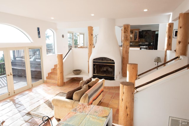 tiled living area featuring stairway, a fireplace, visible vents, and recessed lighting