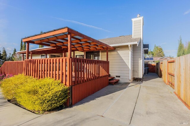 view of property exterior featuring crawl space, a chimney, and fence