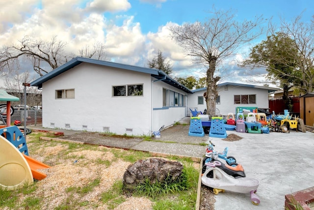 view of home's exterior featuring crawl space, a patio area, fence, and stucco siding