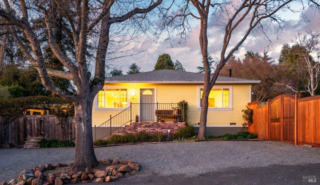 bungalow-style house featuring crawl space, fence, and a gate