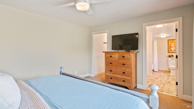 carpeted bedroom featuring baseboards and a ceiling fan