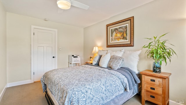 bedroom featuring light carpet, baseboards, and a ceiling fan