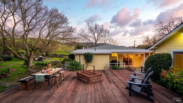 deck with outdoor dining area and a grill