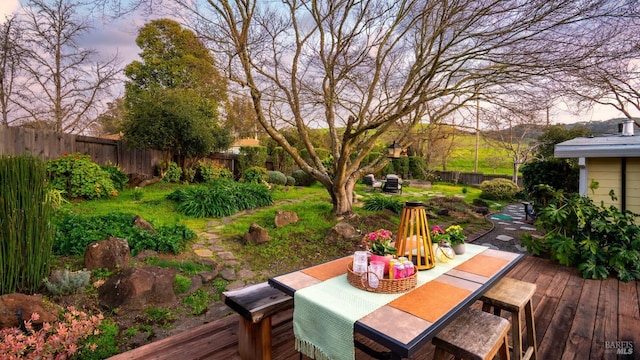 wooden deck featuring outdoor dining space and fence private yard