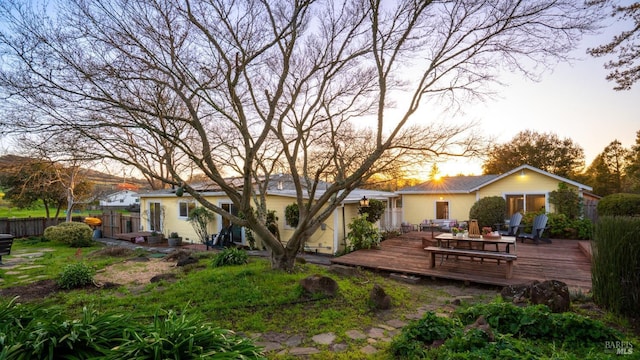 back of property featuring fence and a wooden deck