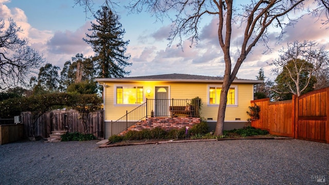 bungalow-style home featuring crawl space and fence