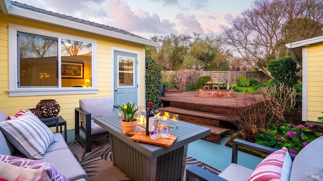 wooden deck with fence and an outdoor living space