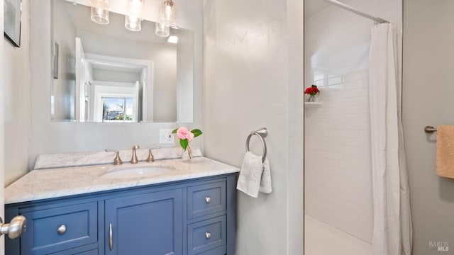 full bath with a stall shower and vanity