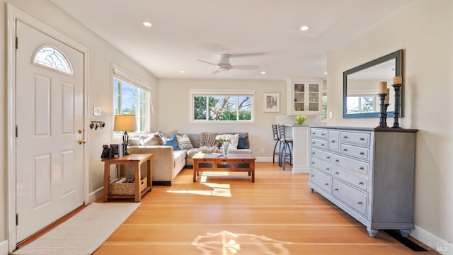 interior space featuring light wood-style flooring, baseboards, and recessed lighting