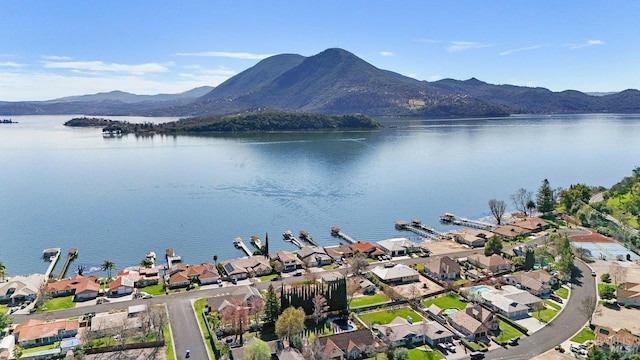 aerial view featuring a water and mountain view and a residential view