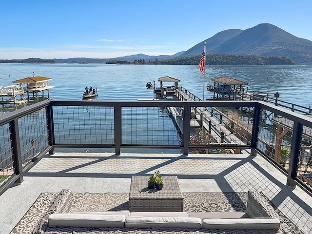 balcony featuring a water and mountain view