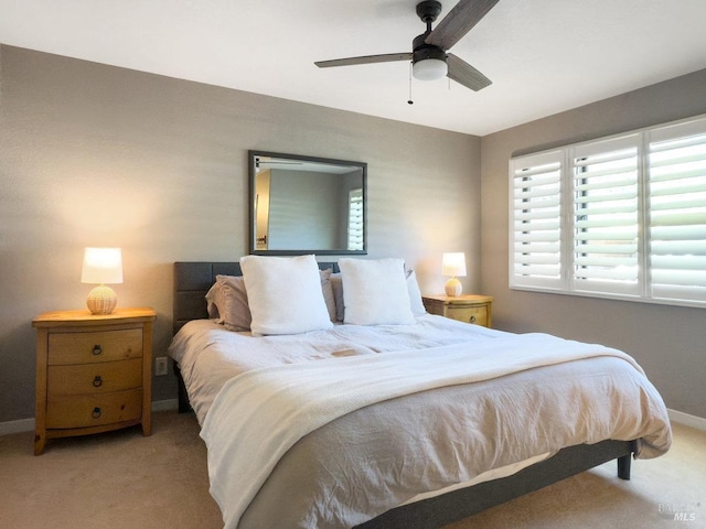 bedroom with carpet floors, baseboards, and a ceiling fan