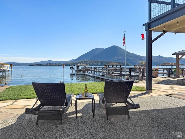 view of patio / terrace featuring a boat dock and a mountain view