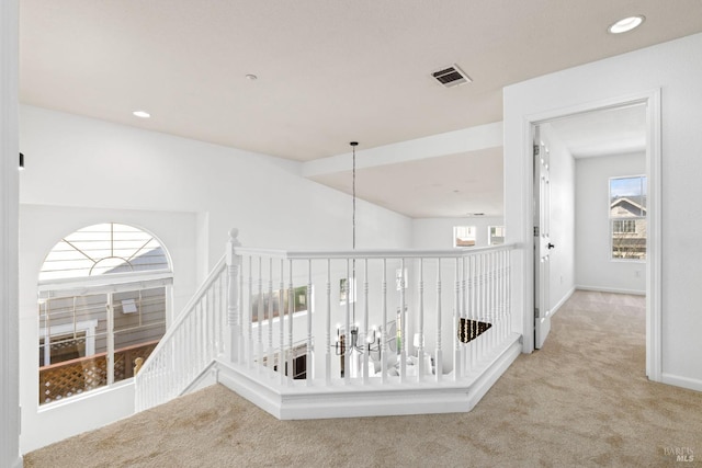 corridor with carpet floors, recessed lighting, visible vents, and baseboards