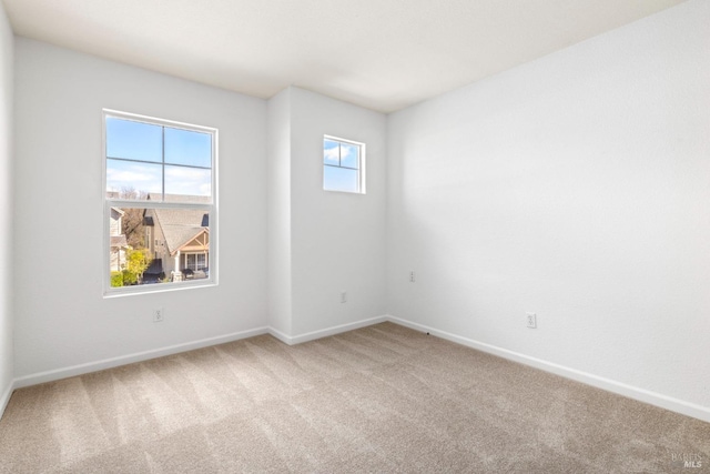 empty room with baseboards and carpet flooring