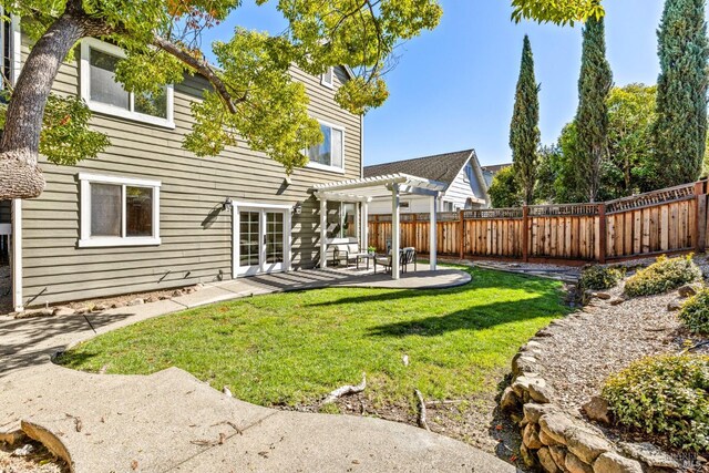 back of house featuring a patio, a yard, a fenced backyard, and a pergola