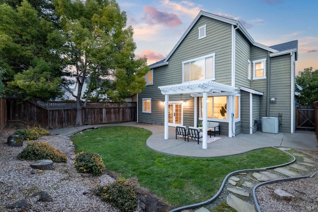 back of house with a pergola, a patio, a fenced backyard, french doors, and central AC