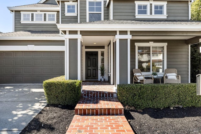 entrance to property with driveway, a porch, and roof with shingles