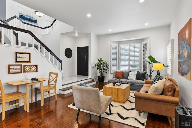 living room with recessed lighting, stairway, baseboards, and wood finished floors