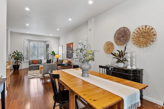 dining space with recessed lighting, dark wood-style flooring, and baseboards