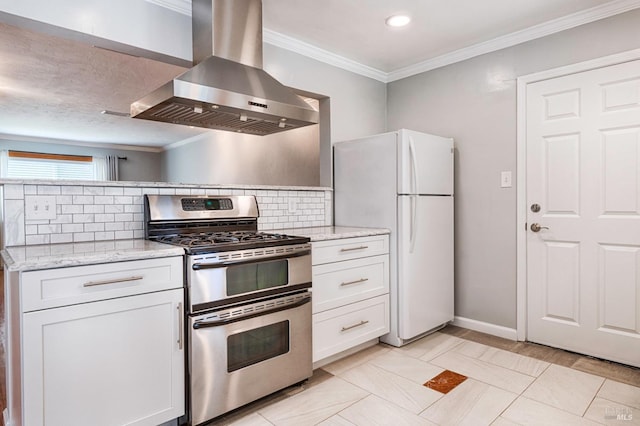 kitchen with wall chimney exhaust hood, double oven range, crown molding, and freestanding refrigerator