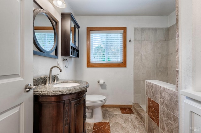 full bathroom with toilet, baseboards, a walk in shower, and vanity