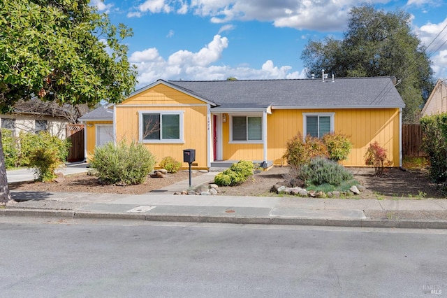 view of front of home featuring a garage and fence