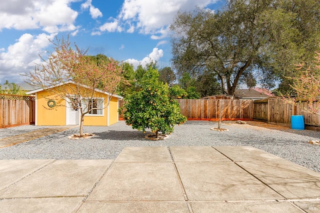 view of patio with an outbuilding and a fenced backyard