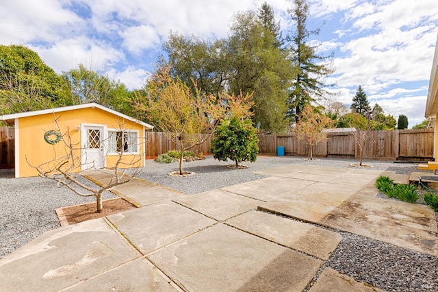 view of patio / terrace with an outbuilding and a fenced backyard