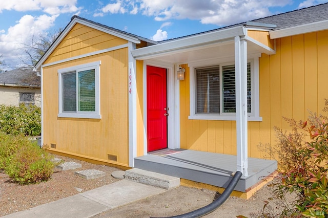 exterior space featuring roof with shingles and crawl space