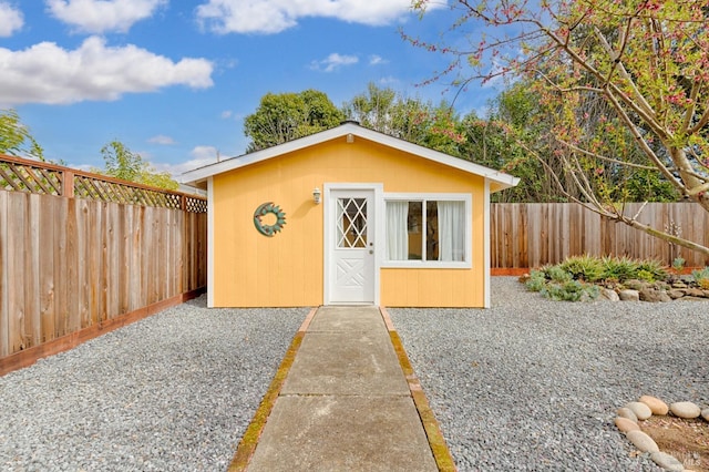 view of outbuilding featuring a fenced backyard and an outbuilding