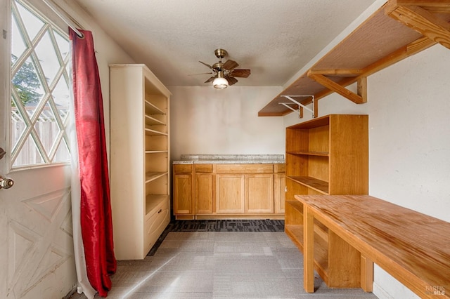 walk in closet with ceiling fan