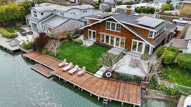 drone / aerial view with a water view and a residential view