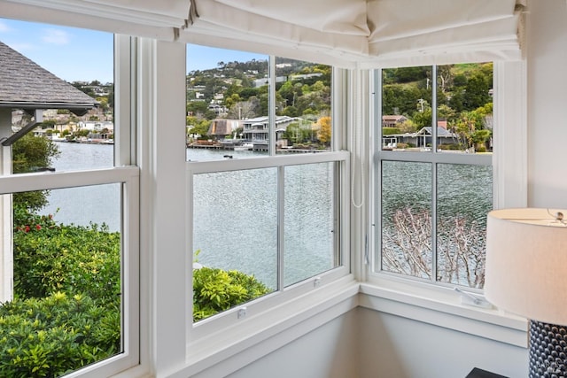 unfurnished sunroom with a water view