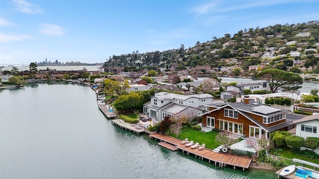 birds eye view of property with a water view and a residential view