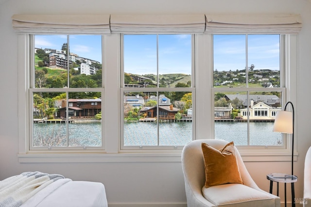 bedroom with a water view and multiple windows