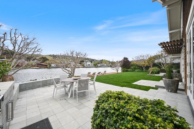 view of patio featuring a water view and outdoor dining space