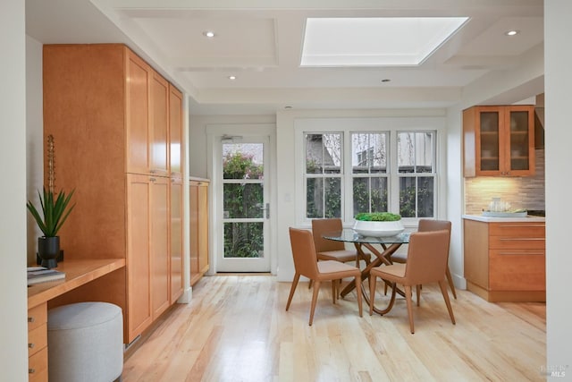 interior space with a skylight, coffered ceiling, and beamed ceiling