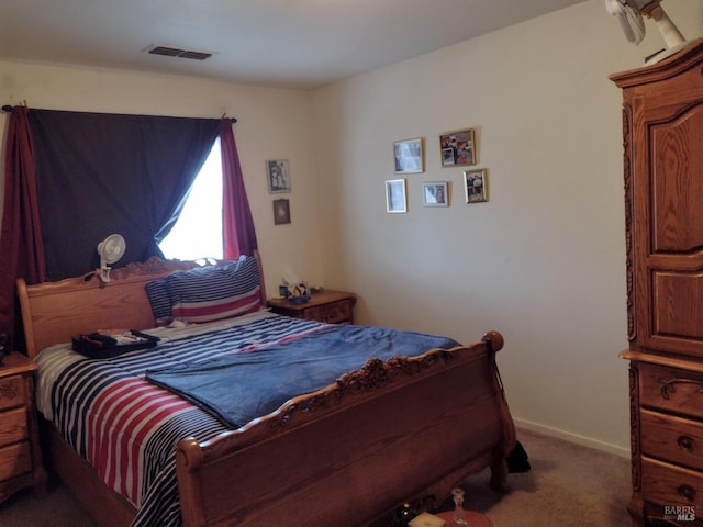 carpeted bedroom with visible vents and baseboards