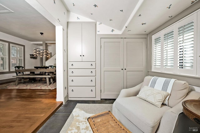 living area with lofted ceiling and dark wood-style floors