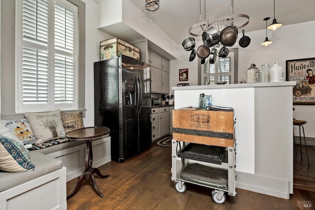 kitchen with dark wood-style floors and black fridge