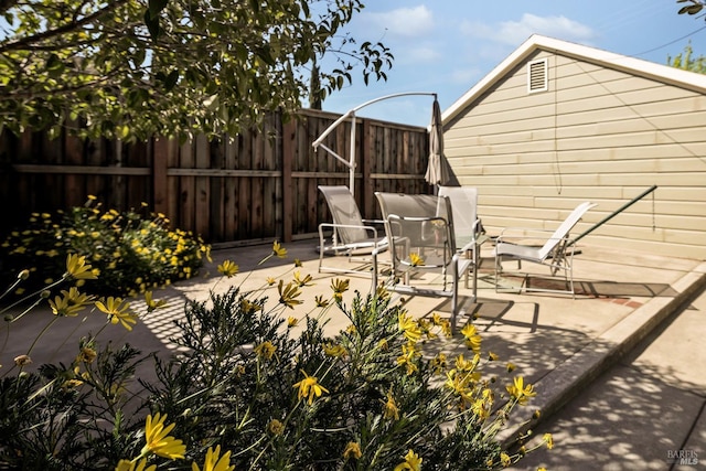 view of patio featuring fence