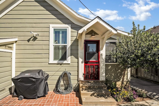 view of exterior entry with fence