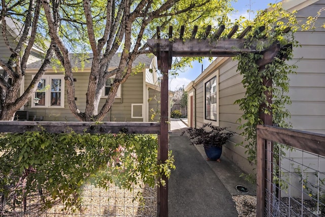 view of side of property with a patio area and fence