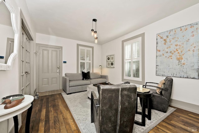 dining area featuring baseboards and hardwood / wood-style floors