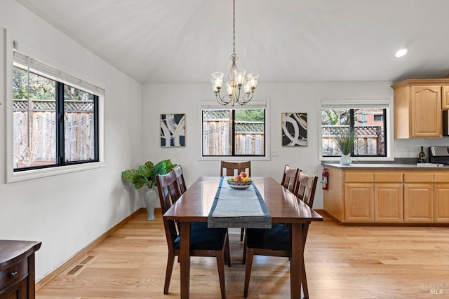 dining room featuring light wood-style floors, visible vents, baseboards, and an inviting chandelier