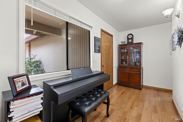 misc room with light wood-style floors and baseboards