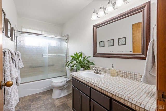 full bath with toilet, combined bath / shower with glass door, and vanity