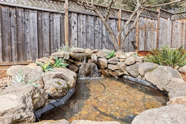 details with a small pond and fence